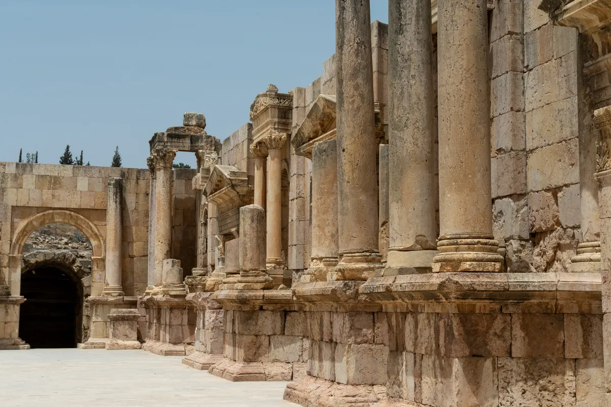 A row of ancient Roman colonnade columns with carved capitals, Jerash, Jordan