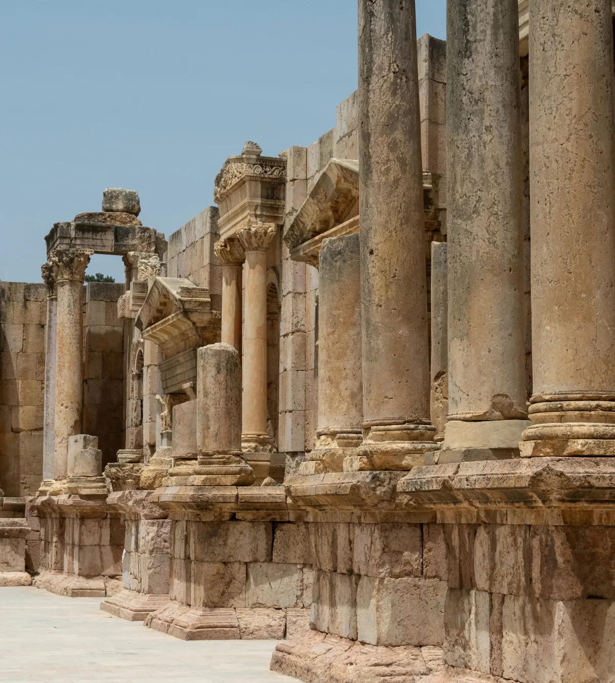 A row of ancient Roman colonnade columns with carved capitals, Jerash, Jordan