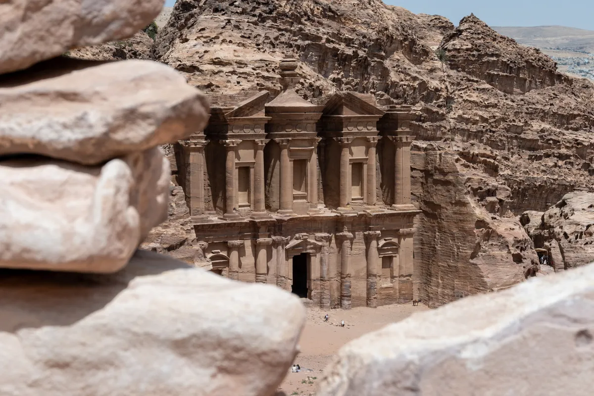 The rock-cut facade of Ad Deir (the Monastery) framed by boulders, Petra, Jordan
