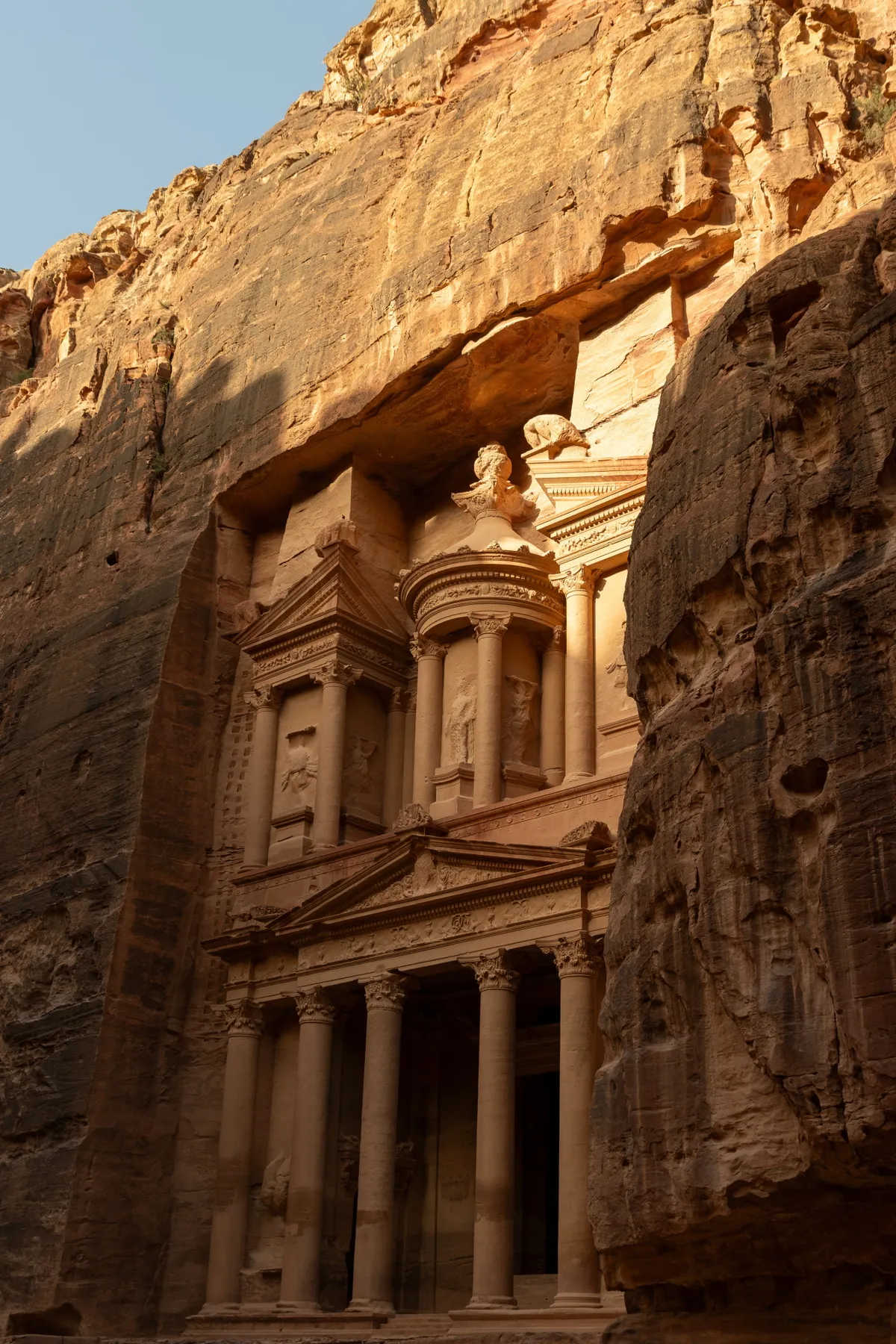 The Treasury (Al-Khazneh) glowing amber in golden-hour light, Petra, Jordan