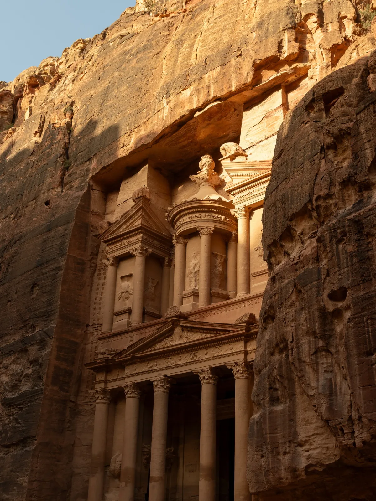 The Treasury (Al-Khazneh) glowing amber in golden-hour light, Petra, Jordan