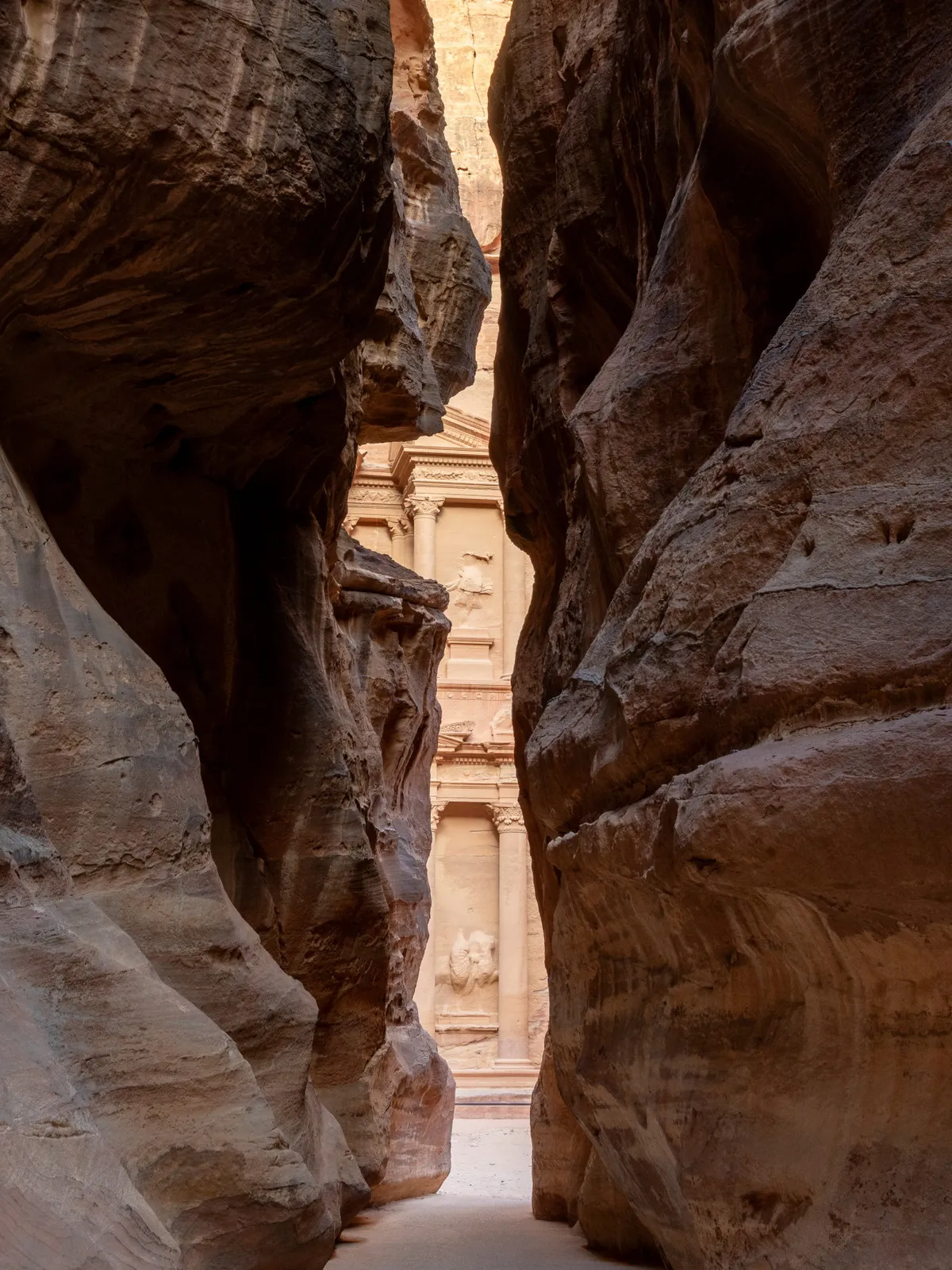 First glimpse of the Treasury framed at the end of the Siq, Petra, Jordan
