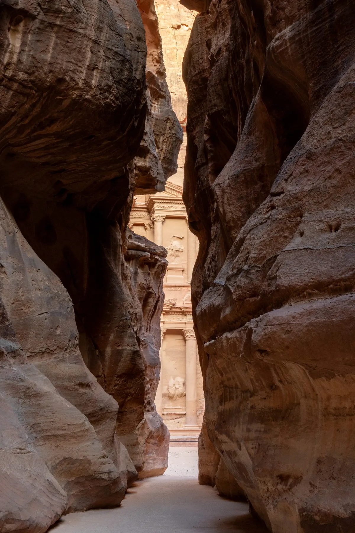 First glimpse of the Treasury framed at the end of the Siq, Petra, Jordan